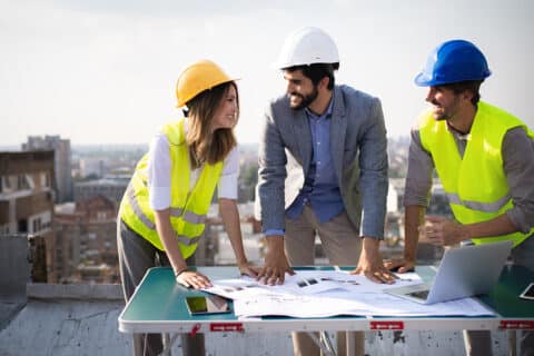 architects, business manager and engineer meeting project at building site