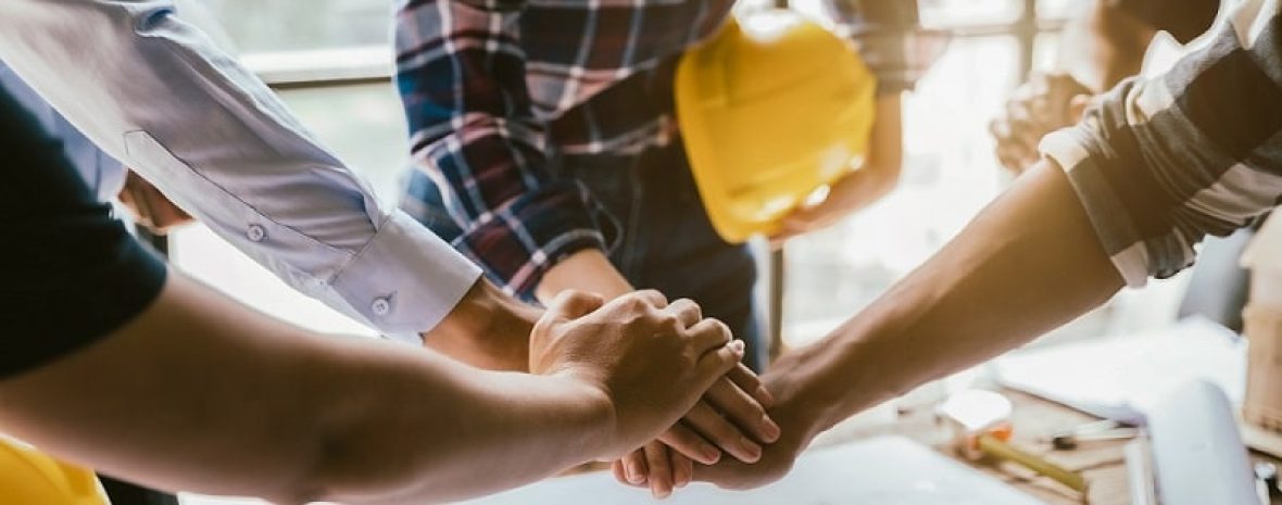 construction worker and contractor. client shaking hands with te